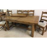 A large, heavy solid oak draw leaf rustic dining table with separate leaf.