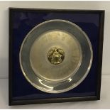 A mounted and framed hallmarked silver commemorative platter.