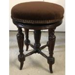 A Victorian mahogany screw top piano stool with turned detail to legs and brown velvet upholstery.