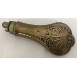 A copper and brass powder flask with classic clam shell decoration by Drake.