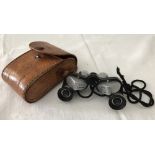 A leather cased pair of small binoculars by Wolf.