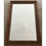 A modern wood framed wall hanging mirror.