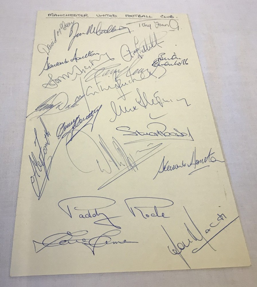 A set of 19 Manchester United footballer signatures on a single sheet from the 1974/5 season.