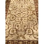A large brown, gold and beige rug.