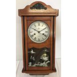A Wooden cased 15 day wall clock by C. Wood & Sons.