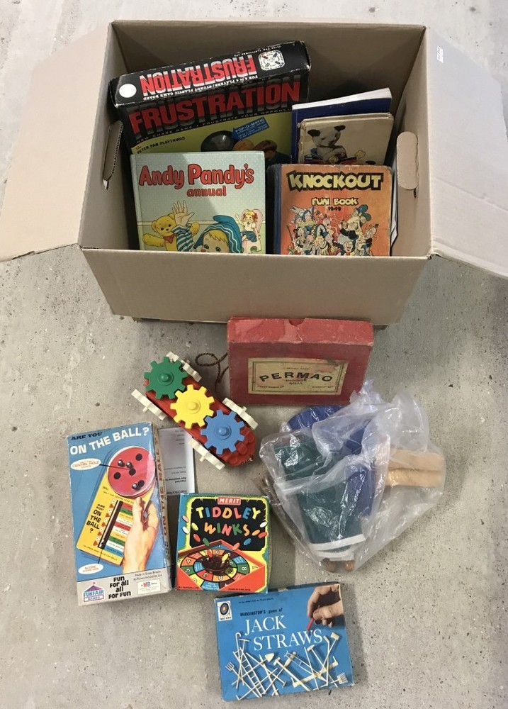 A box of assorted vintage toys and games.