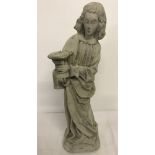 A concrete figurine of a classical robed lady.