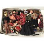A box of vintage dolls many wearing National Costumes.