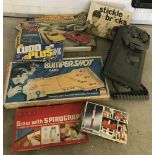 Action Man plastic tank together with a collection of boxed vintage games.