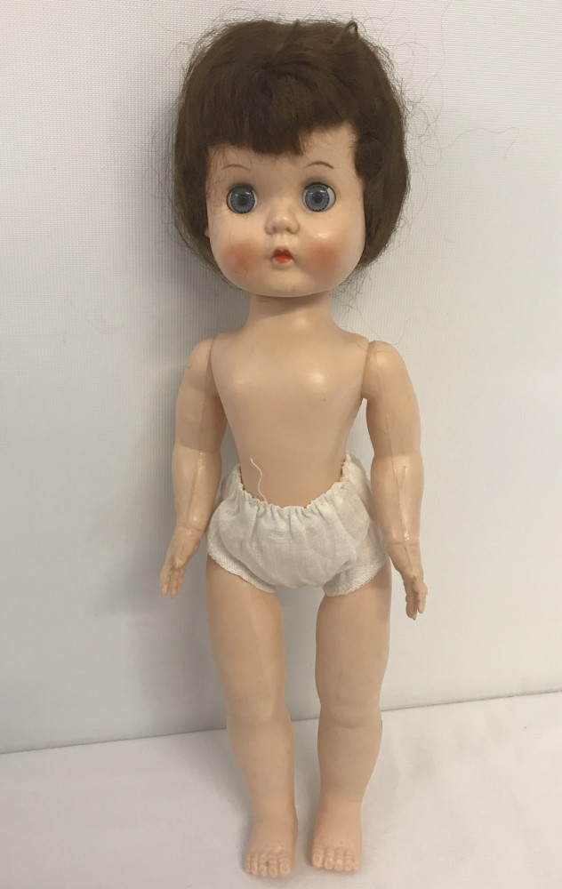 A 1950's hard plastic "Roddy" walker doll with no clothes.