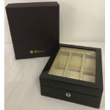 A brand new black lacquer watch box with geometric design.