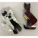 2 plastic Leah Stein style brooches in the shape of a cat and a dog.