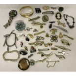 A small collection of vintage costume jewellery brooches and bracelets.