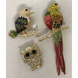 3 stone set brooches in the shape of birds.