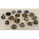 A collection of 925 silver and Murano glass bracelet charms.