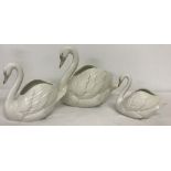 3 unboxed Nao swan posy vases in graduated sizes.