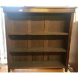 A vintage dark wood 3 shelf bookcase with adjustable shelves.