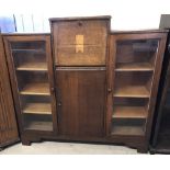 A vintage dark wood bookcase / display unit with 2 glass fronted doors and 2 central cupboards.