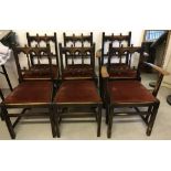 A set of 6 dark wood dining chairs with rust coloured upholstered seats and turned spindle backs.