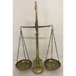 Pair of vintage brass balance scales with weights (smallest one missing).