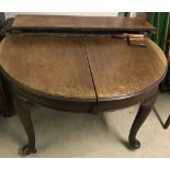 A Victorian circular wind out dining table with cabriole legs.