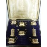 A George V silver eight piece cruet set