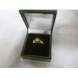 An 18ct gold engagement ring set a diamo