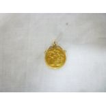 A gold pendant mounted with a 1906 gold