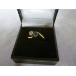 An 18ct gold engagement ring set a diamo