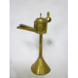 An old brass open flame lamp with tapere