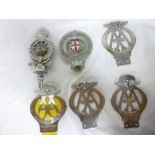 Six various old car badges including Roy