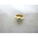 A 14ct gold dress ring set an opal flank