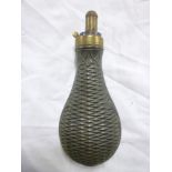 An old brass mounted copper powder flask