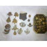 A small selection of original military cap badges including 1916 emergency issue DCLI badge by J R