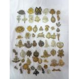 A selection of over 40 various military cap badges and insignia including Bedfordshire and