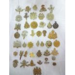 A collection of over 30 various military cap badges, mainly original including Army Cyclist Corps,