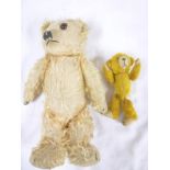 A small old plush covered teddy bear, 6½" long and one other plush covered teddy bear,