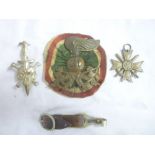 An Italian brass cap badge with satin cockade, German Nazi death's head badge,