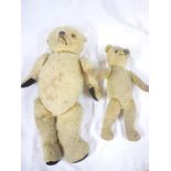An old plush covered teddy bear with pointed snout,