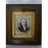 A 19th Century miniature oval portrait depicting a bust portrait of a gentleman in stained wood and