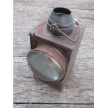 A railway lamp stamped "LEISTON" with reservoir,