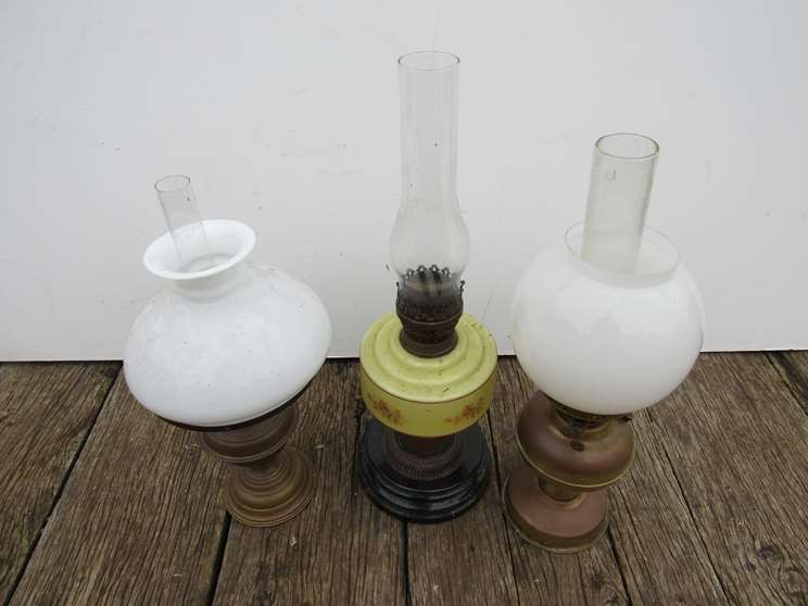 Three various oil lamps with opaque glass shades