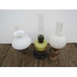 Three various oil lamps with opaque glass shades