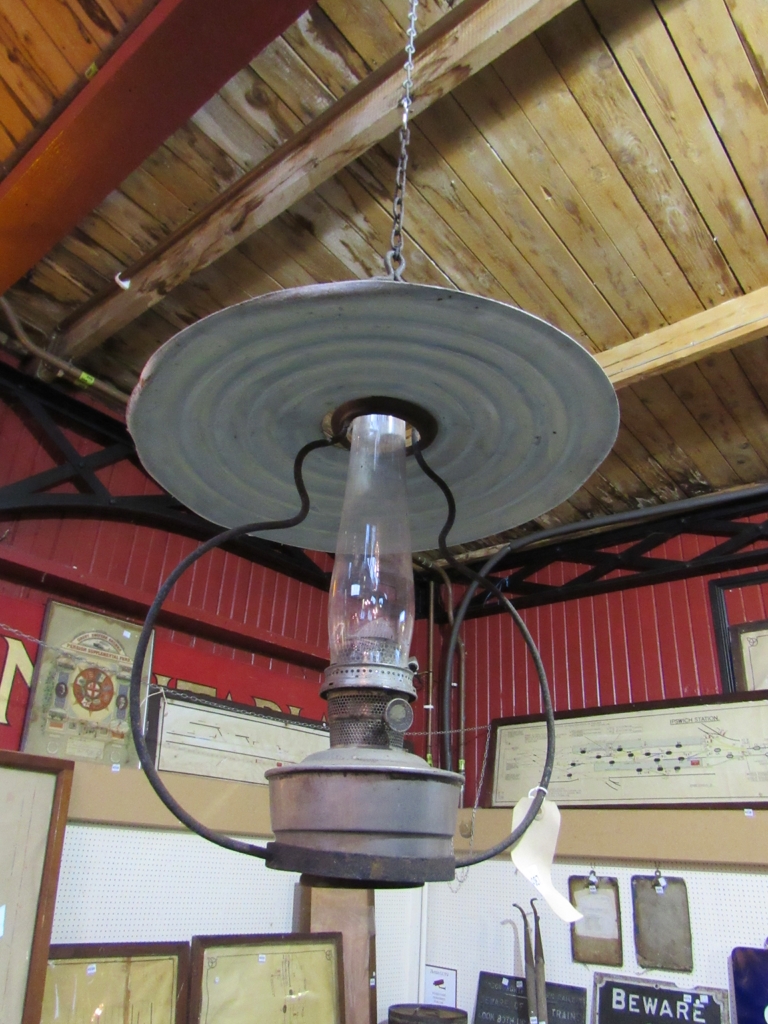 A railway signal box ceiling hanging oil lamp with reservoir,
