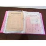 A folder containing various paper invoices relating to businesses in HALESWORTH