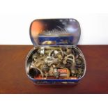 Two tins containing various tilly lamp parts and the other containing various scissors, keys,