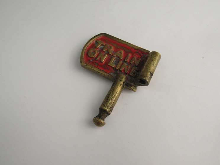 A brass single line key token with "TRAIN ON LINE" and "TRAIN PASSED" on each sides - Image 2 of 2