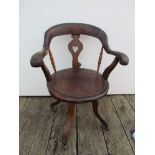 A late Victorian oak captain's style swivel railway station masters desk chair with heart shaped