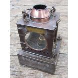 A railway signal lamp interior with reservoir and brass burner,