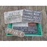 A tray containing six various cast iron and enamel signs to include "WICKHAM MARKET & SOUTHWOLD"